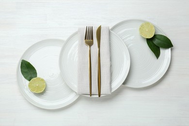 Composition with stylish ceramic plates on white wooden table, top view