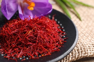 Dried saffron and crocus flowers on table, closeup