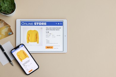 Photo of Online shopping. Flat lay composition with modern tablet and smartphone on beige background