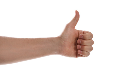 Photo of Man showing thumb up gesture against white background, closeup of hand