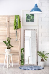 Photo of Modern interior with large stylish mirror with tropical plants