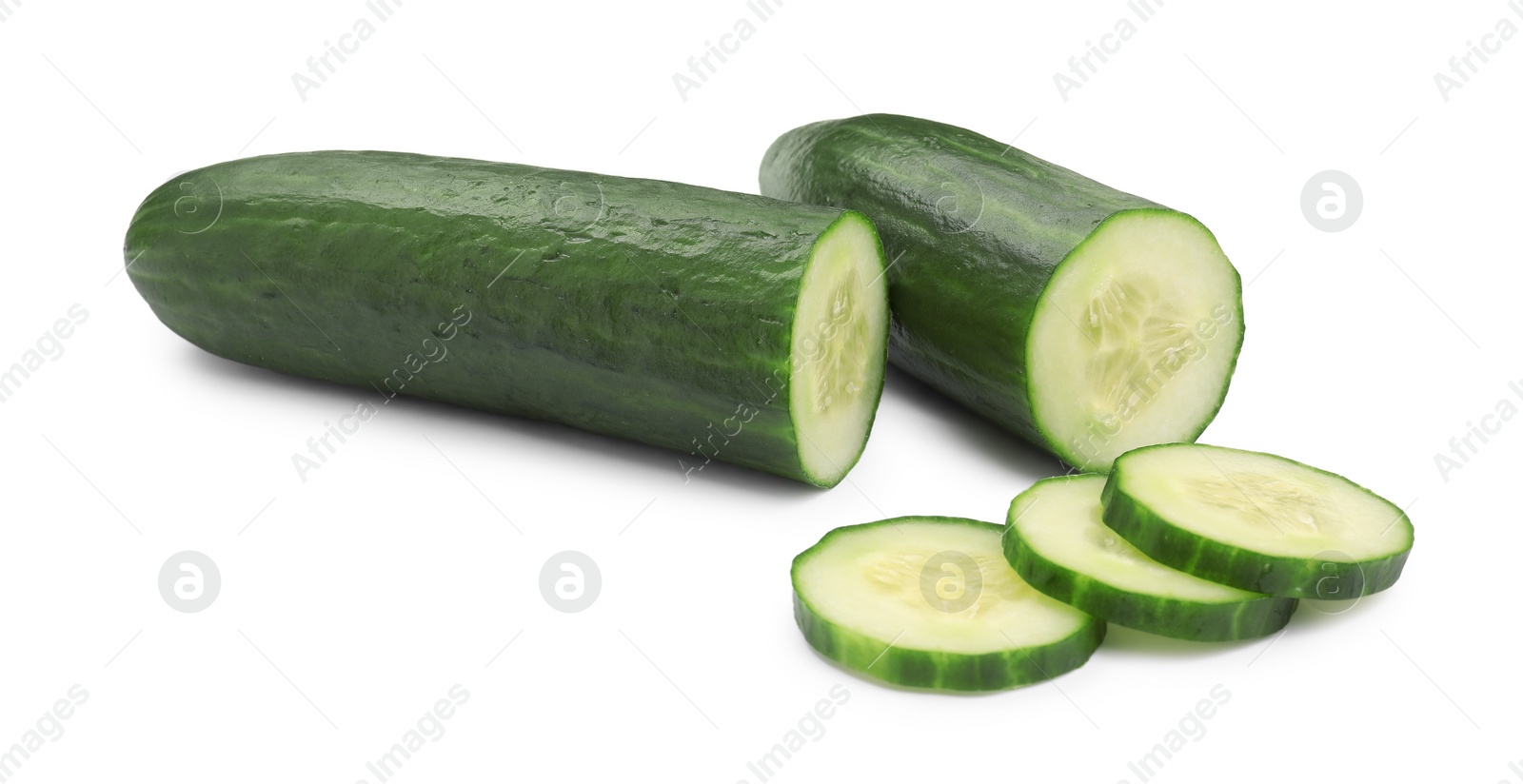Photo of Halves and slices of long cucumber isolated on white