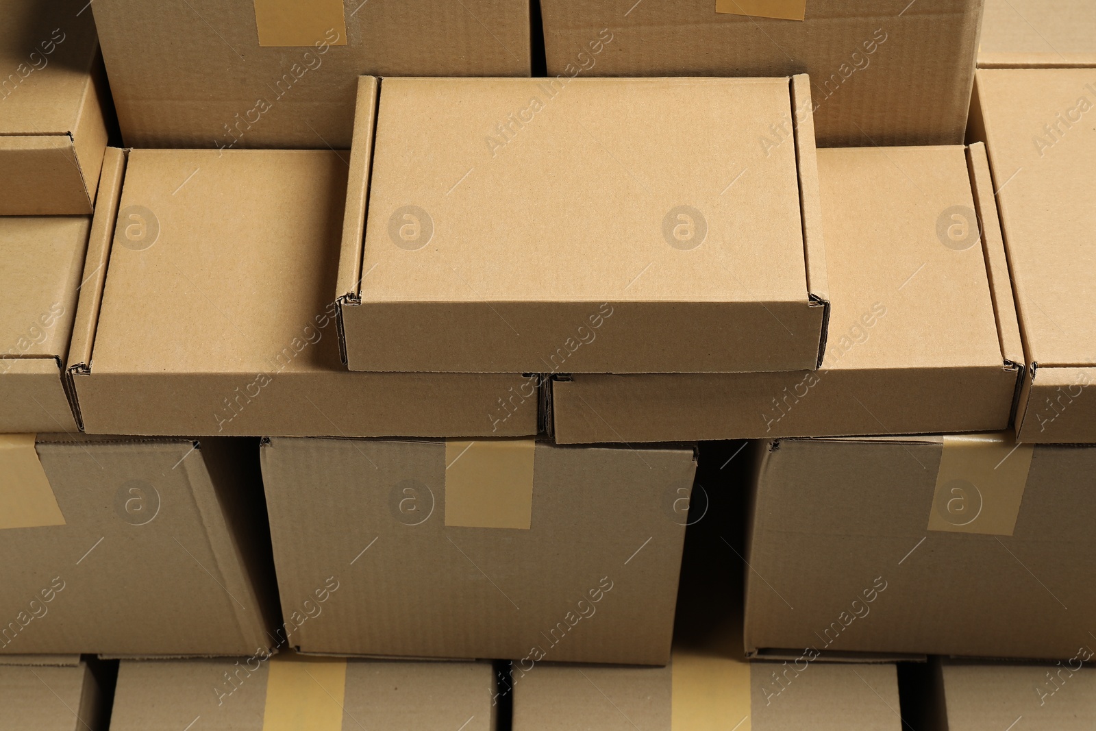 Photo of Many cardboard boxes as background, above view. Packaging goods