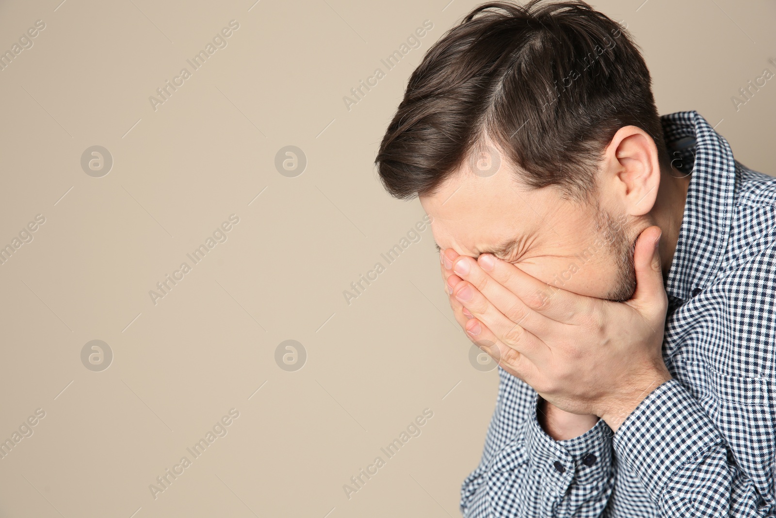 Photo of Man suffering from cough on color background. Space for text