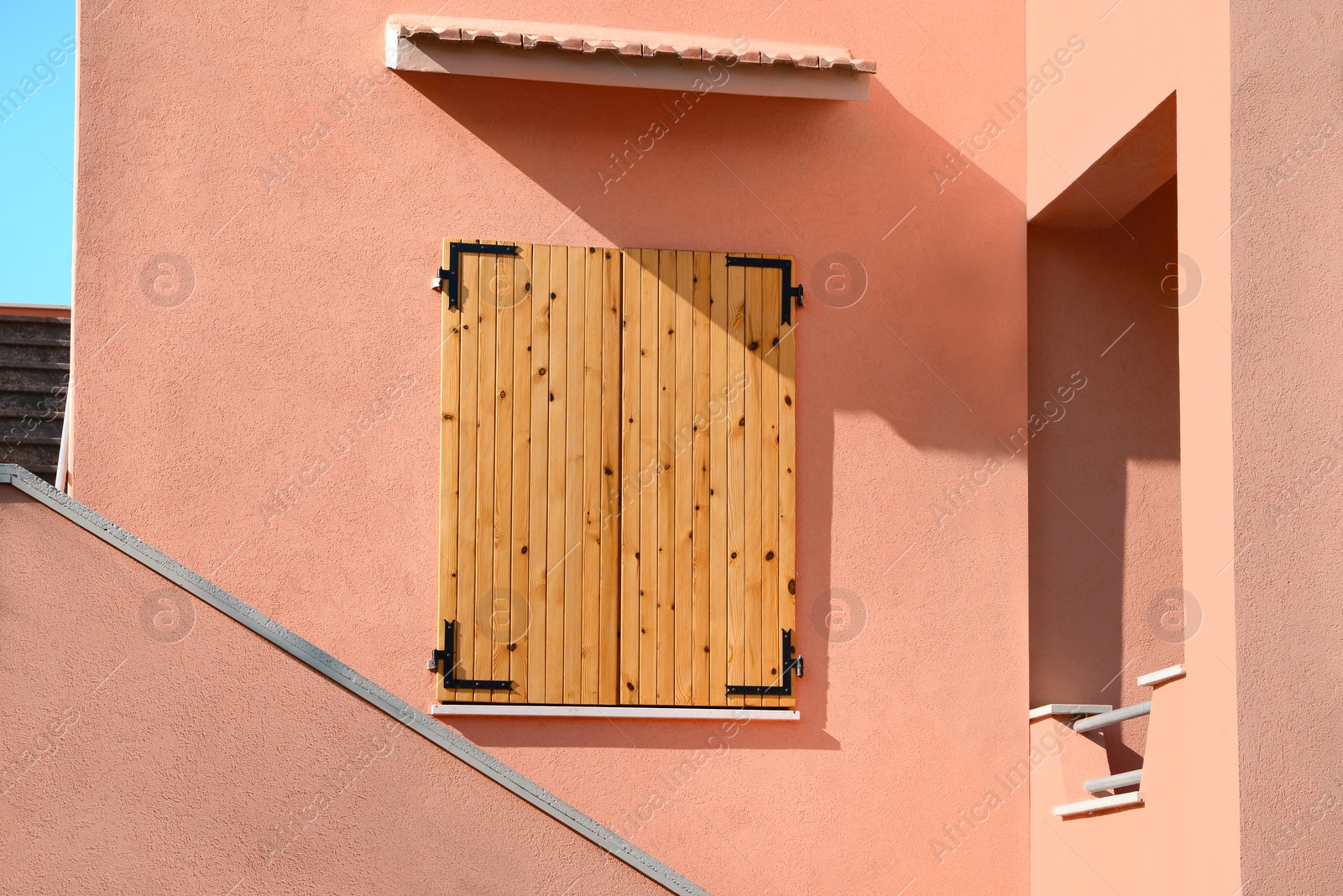 Photo of Modern apartment building with closed window on sunny day