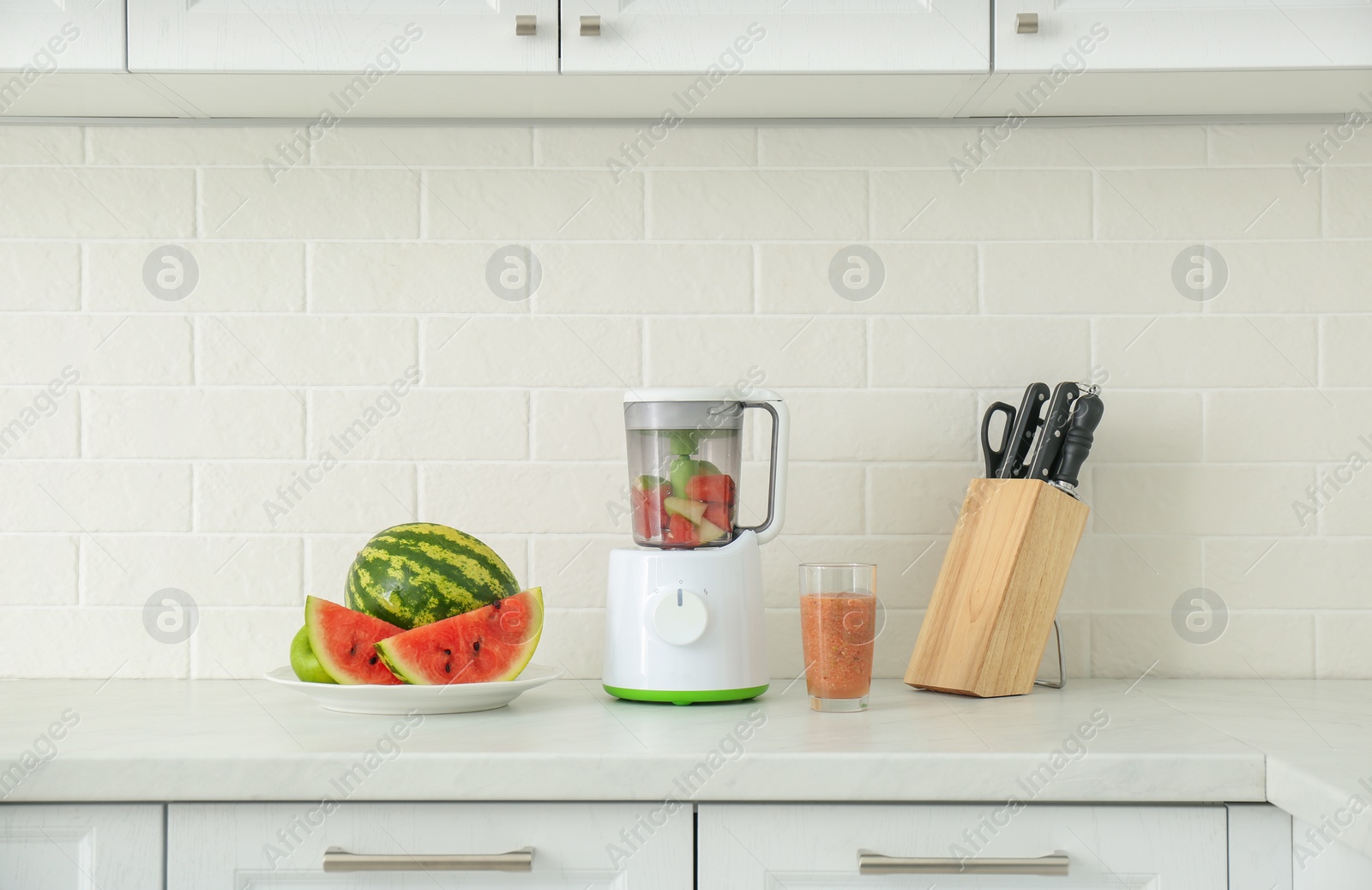 Photo of Blender and smoothie ingredients on counter in kitchen