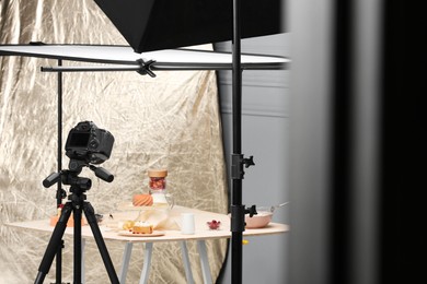 Photo of Professional equipment and composition with delicious desserts on table in studio. Food photography