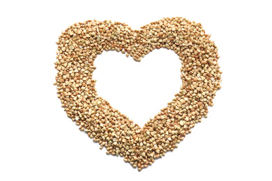 Photo of Heart made with green buckwheat on white background, top view