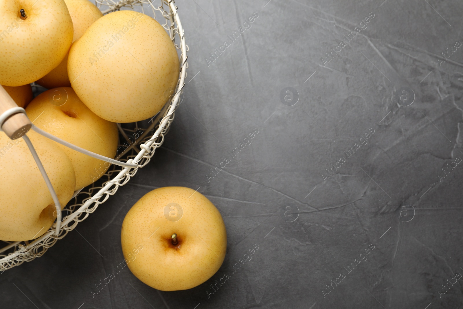 Photo of Ripe apple pears on black table, flat lay. Space for text