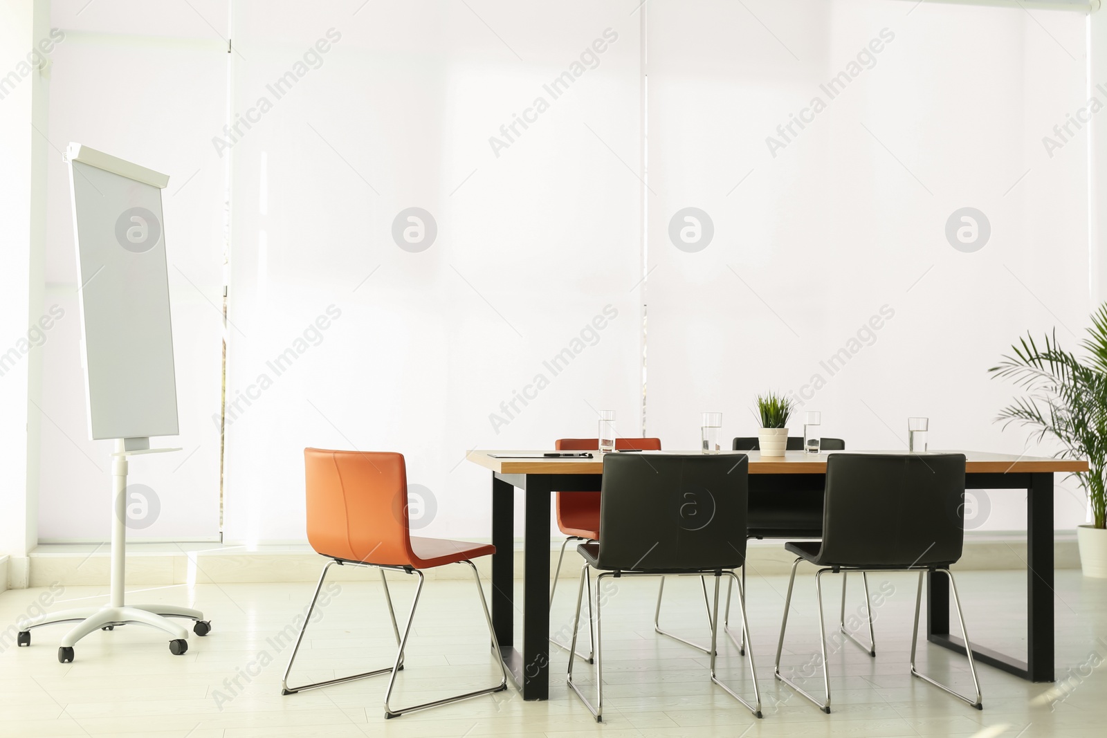 Photo of Simple office interior with large table and chairs