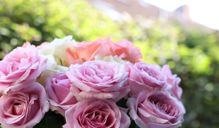 Photo of Beautiful bouquet of aromatic roses outdoors, closeup