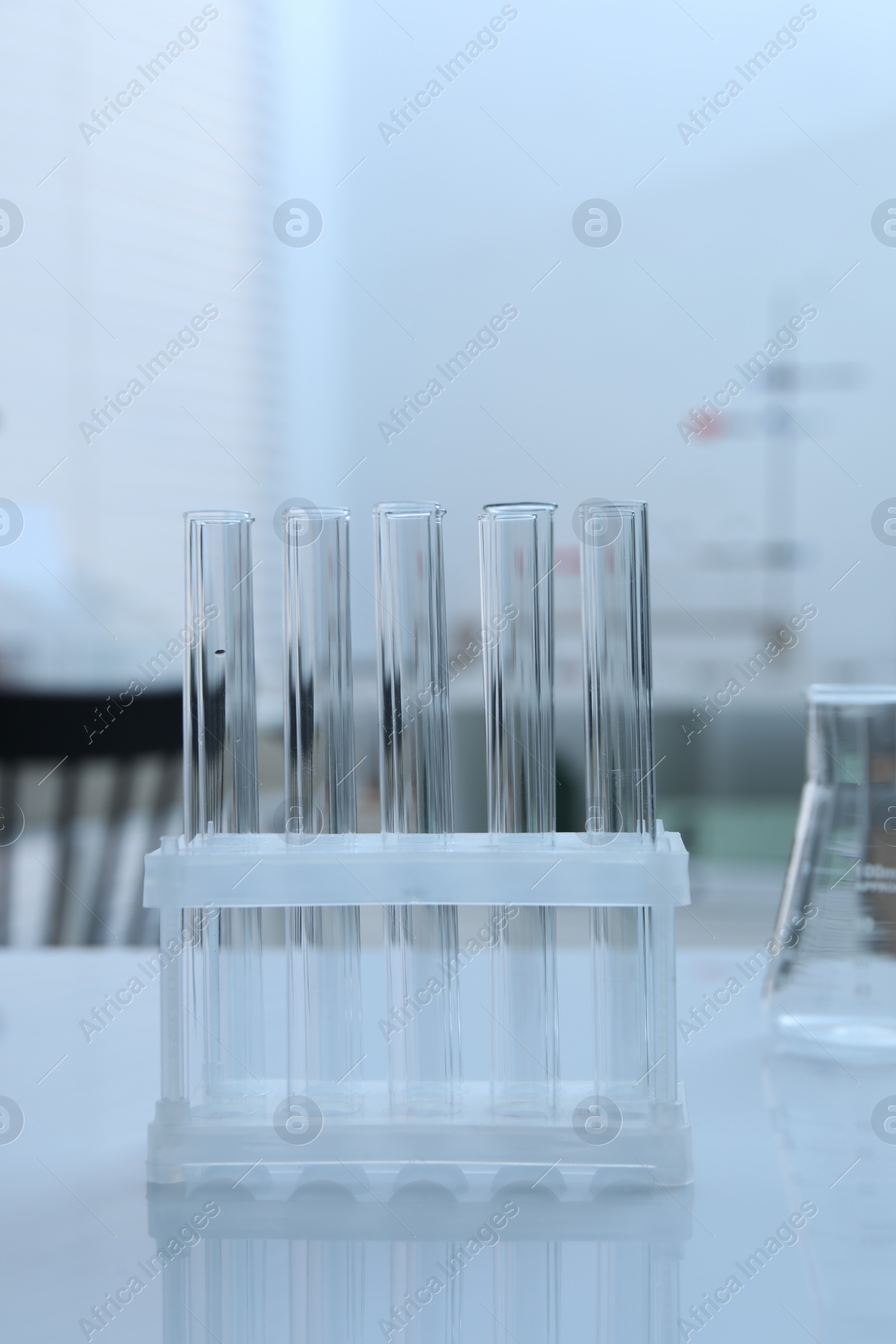 Photo of Laboratory analysis. Glass test tubes on white table indoors