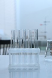 Laboratory analysis. Glass test tubes on white table indoors