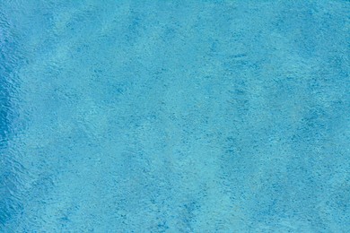 Rippled water in swimming pool as background