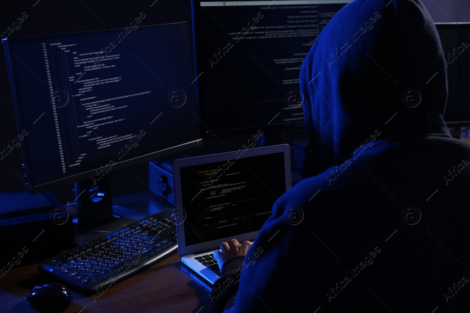 Photo of Hacker with computers in dark room. Cyber crime