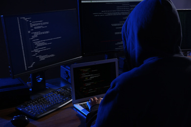 Photo of Hacker with computers in dark room. Cyber crime