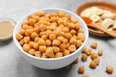 Delicious chickpeas on light grey table, closeup. Hummus ingredient
