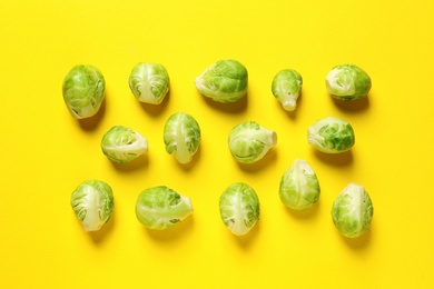 Photo of Fresh Brussels sprouts on color background, flat lay