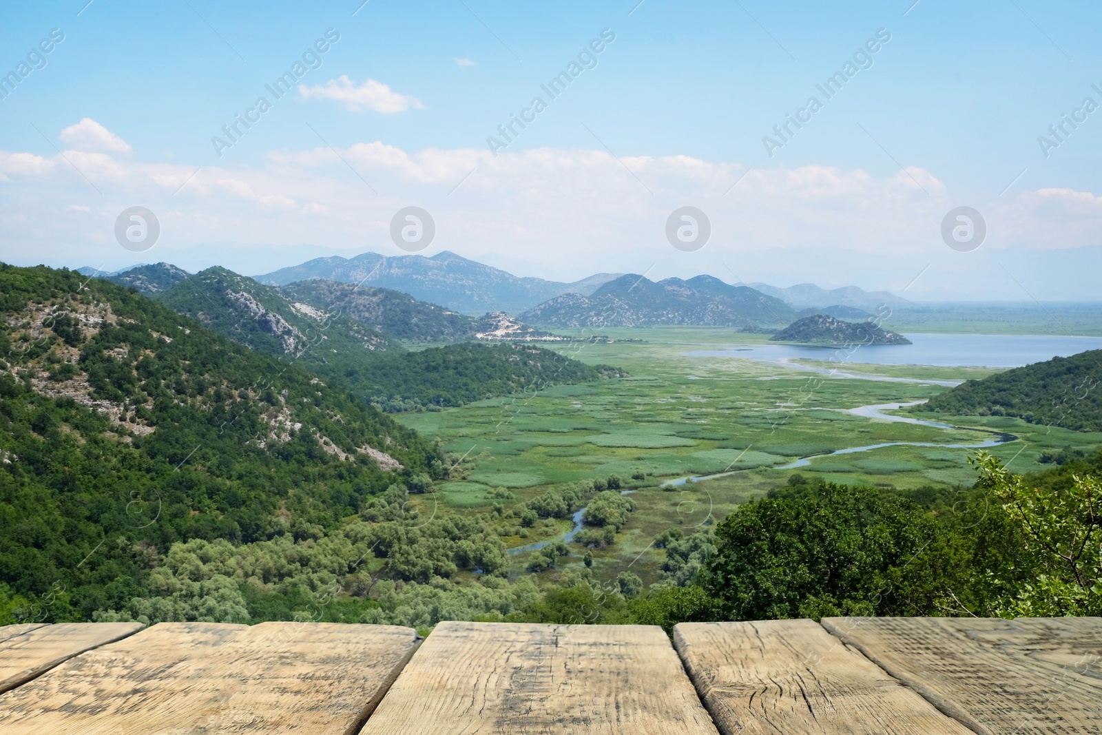 Image of Empty wooden surface and view of beautiful mountains on sunny day