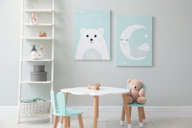 Photo of Children's room interior with table and cute pictures on wall