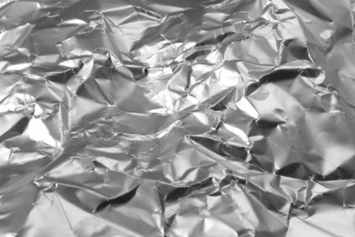 Photo of Crumpled silver foil as background, closeup view