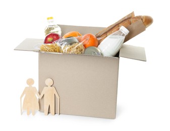 Photo of Humanitarian aid for elderly people. Cardboard box with donation food and wooden figures of couple isolated on white