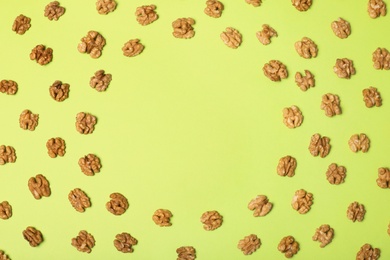 Photo of Group of walnuts on color background, flat lay with space for text