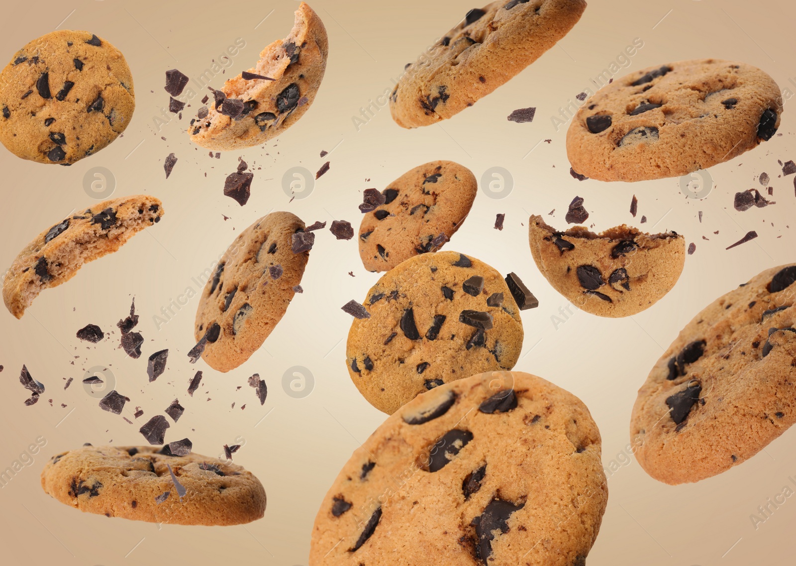 Image of Tasty chocolate chip cookies falling on pale light brown background