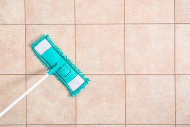 Photo of Cleaning of floor with mop, top view. Space for text