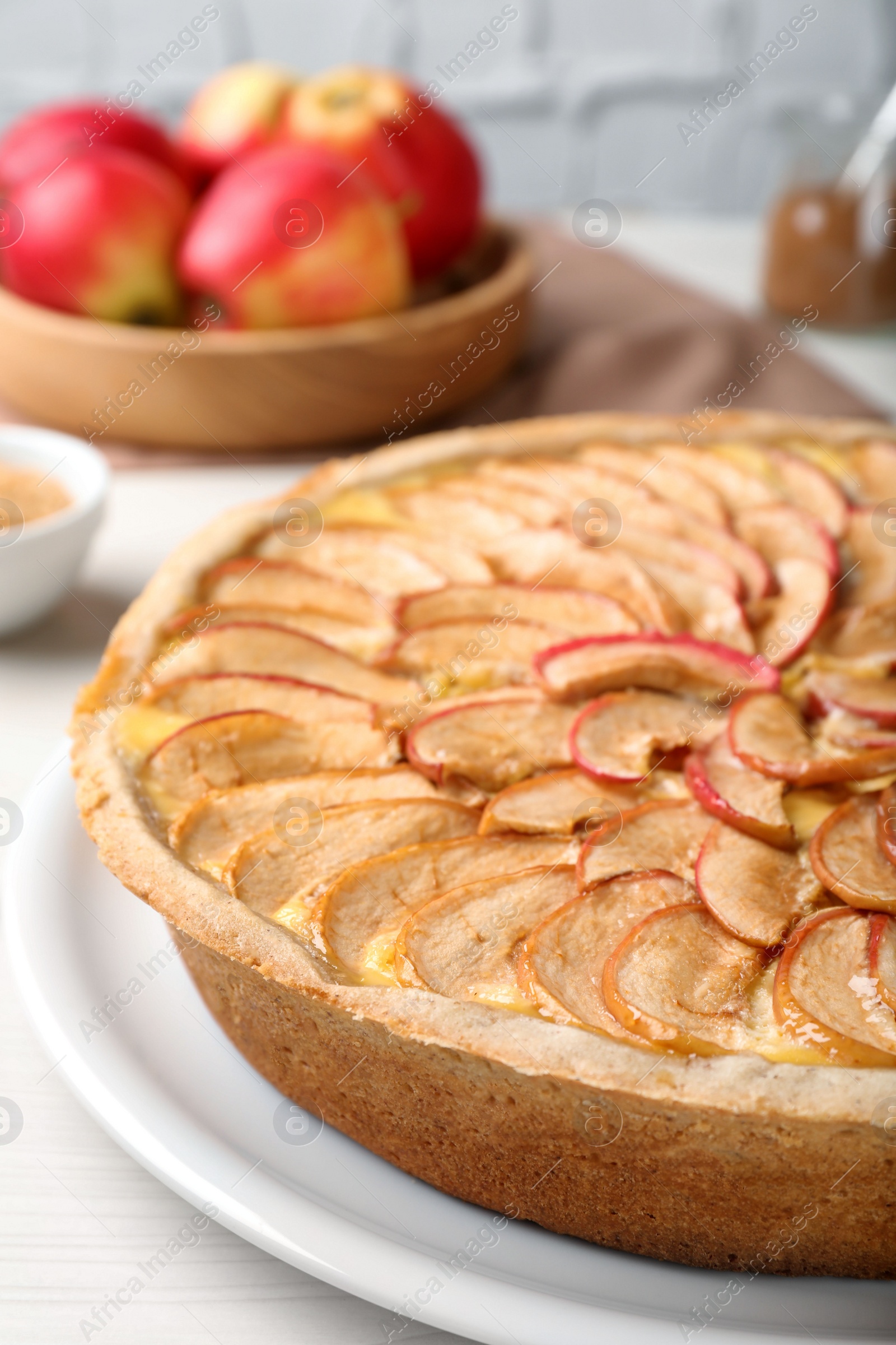 Photo of Tasty apple pie on white table, closeup