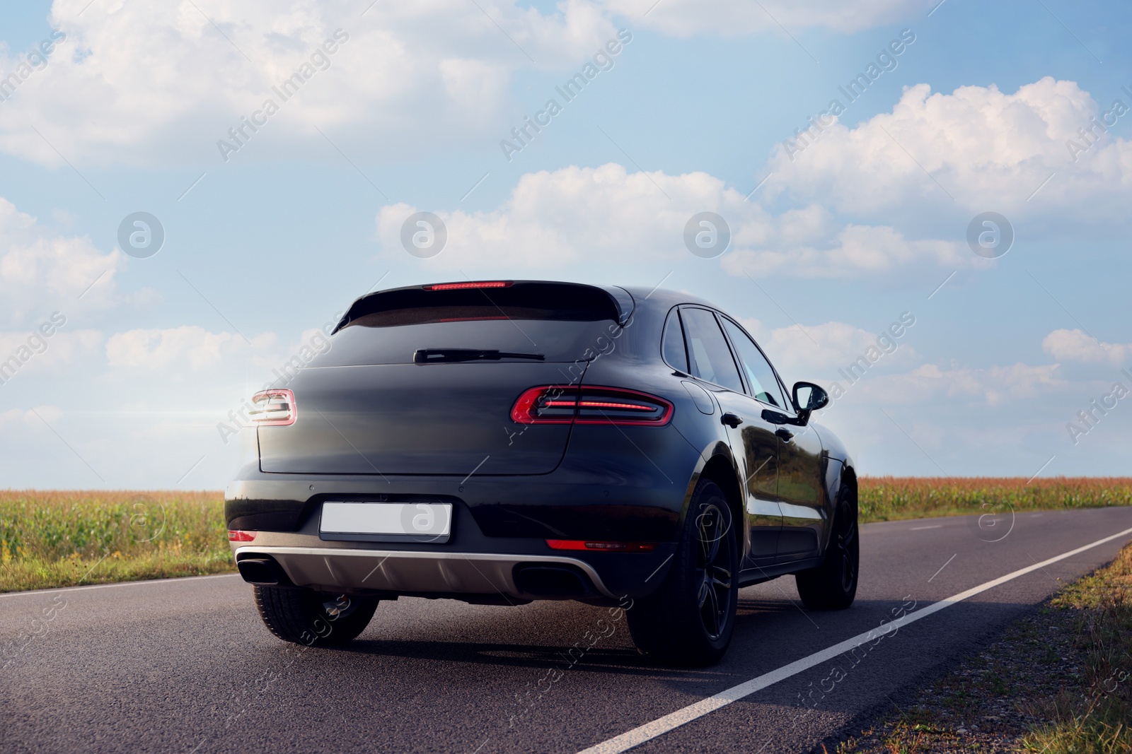 Photo of Modern black car on asphalt road outdoors