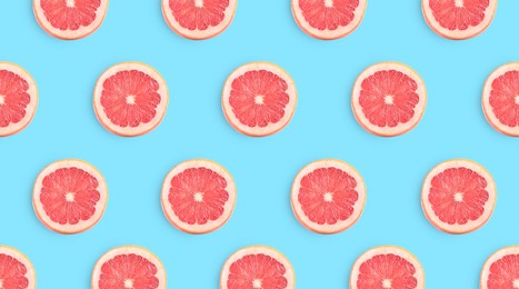 Image of Slices of grapefruits on light blue background, flat lay. Banner design