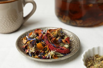 Aromatic dried herbs, fruits and berries for tea on white table