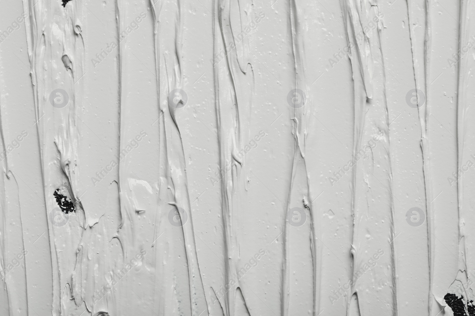 Photo of Strokes of white oil paint as background, closeup