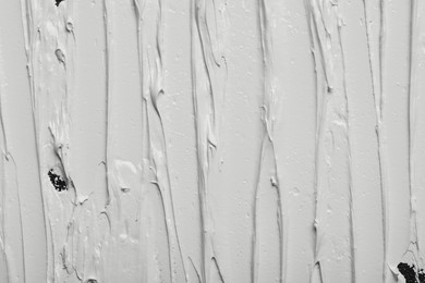 Photo of Strokes of white oil paint as background, closeup