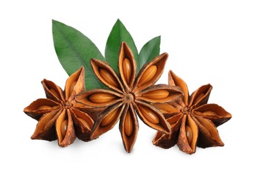 Aromatic dry anise stars and green leaves on white background