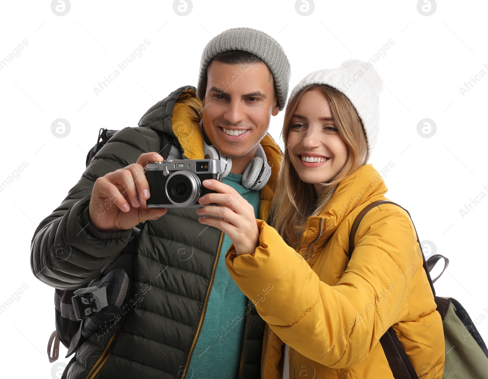 Photo of Couple with camera on white background. Winter travel