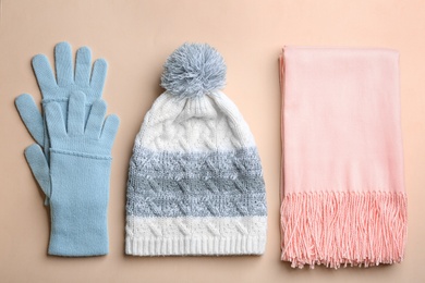 Flat lay composition with warm clothes on beige background