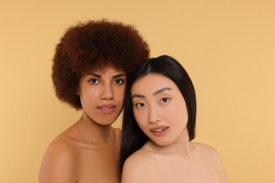 Photo of Portrait of beautiful young women on beige background