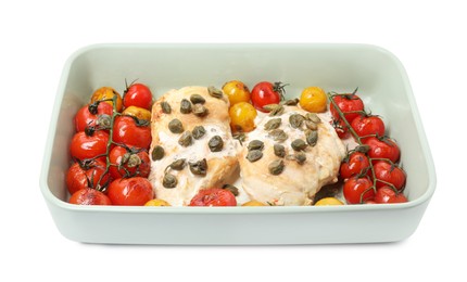 Photo of Delicious chicken fillets with capers, tomatoes and sauce in baking dish isolated on white