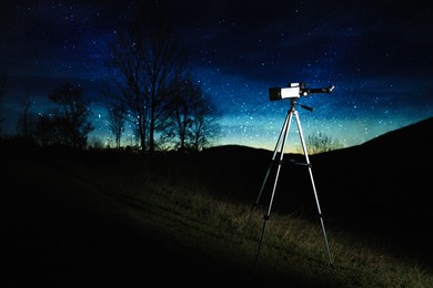Modern telescope and beautiful sky in evening outdoors. Learning astronomy
