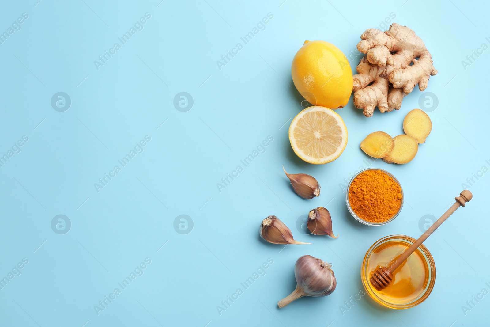 Photo of Flat lay composition with different natural antibiotics on light blue background, space for text