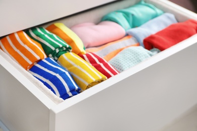 Photo of Many different colorful socks in open drawer, closeup