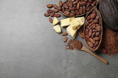 Photo of Flat lay composition with organic cocoa butter on grey table. Space for text