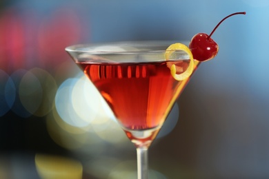Photo of Glass of fresh alcoholic cocktail against blurred background