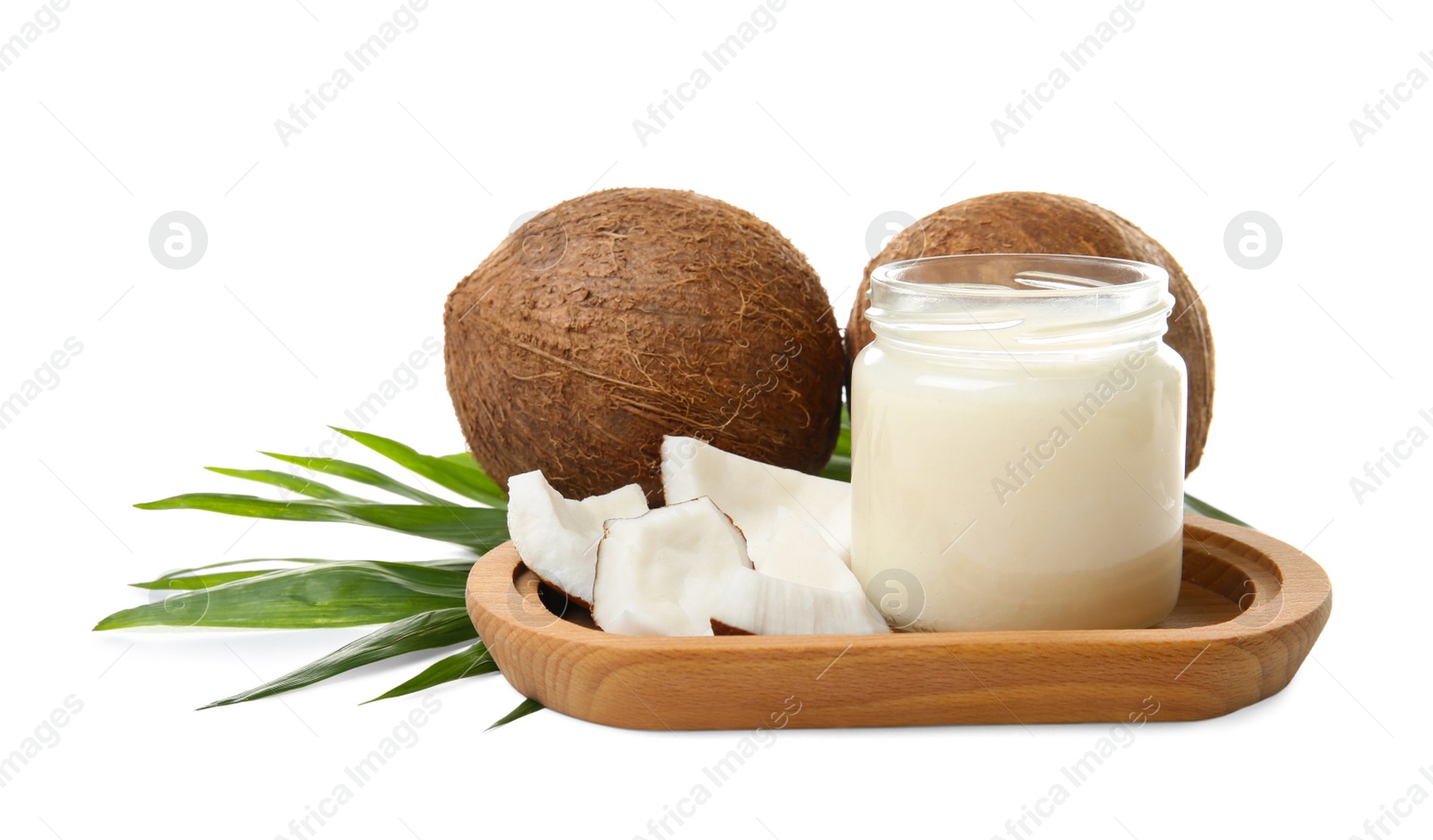 Photo of Jar with coconut oil and nuts on white background