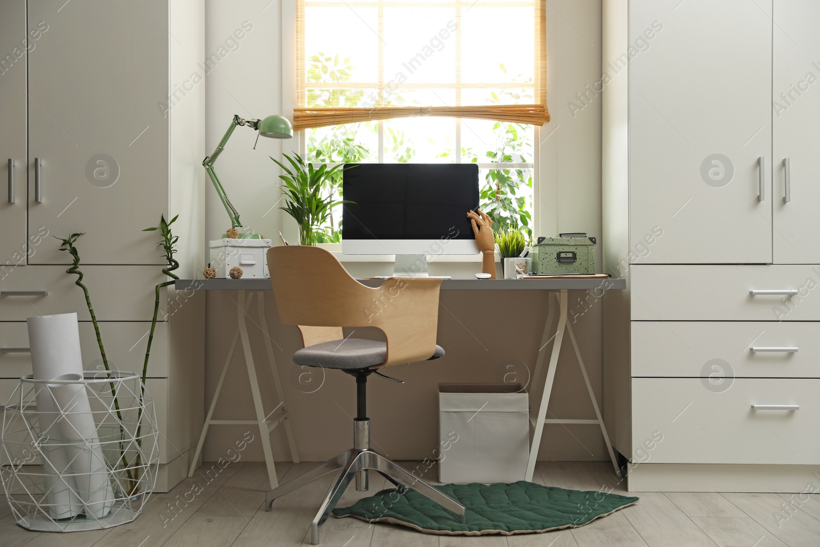 Photo of Light work place with computer near window at home. Interior design