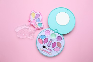Photo of Decorative cosmetics for kids. Eye shadow palettes on pink background, top view