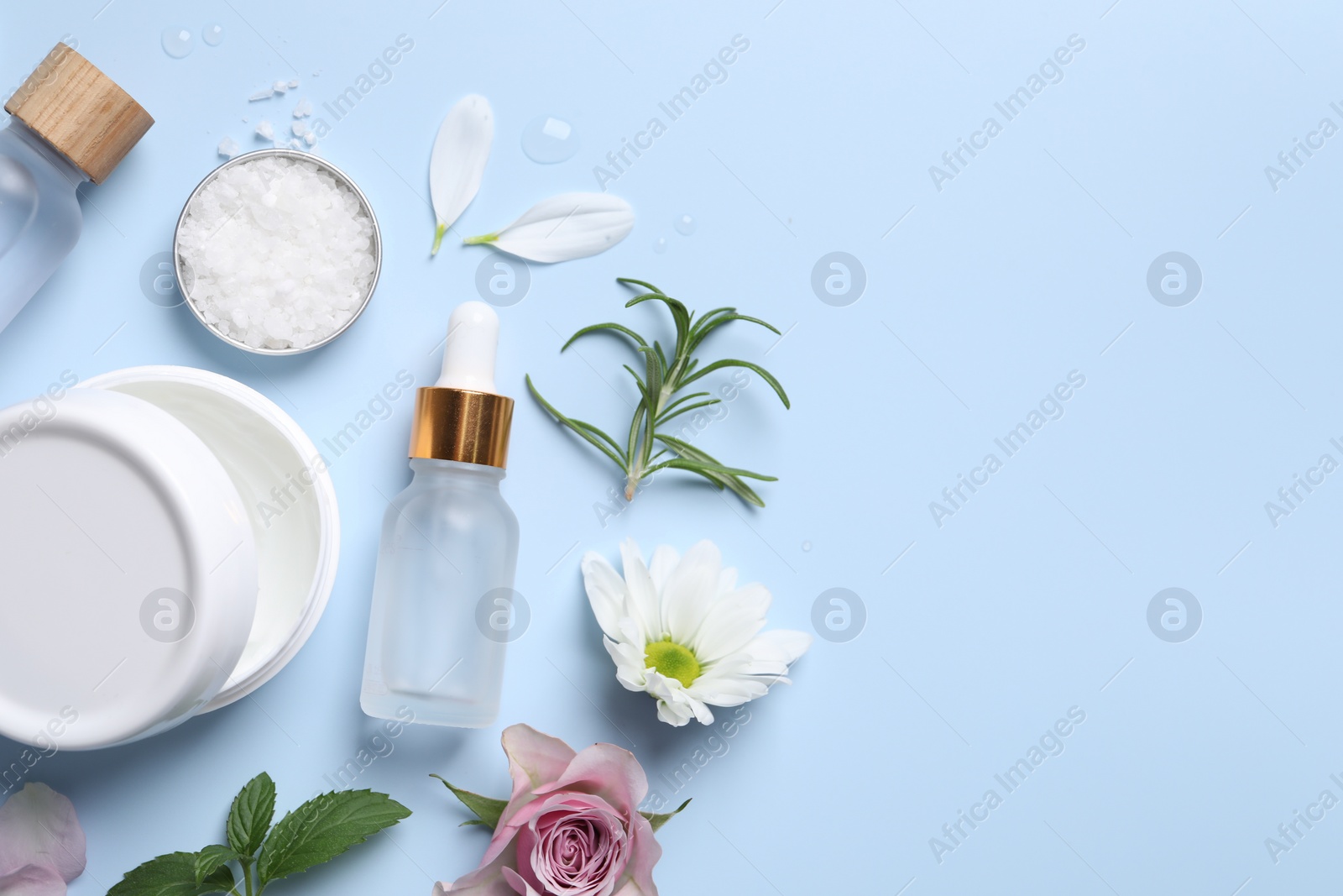 Photo of Flat lay composition with bottles of cosmetic serum on light blue background. Space for text