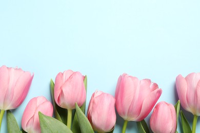 Photo of Happy Mother's Day. Beautiful pink tulips on light blue background, flat lay. Space for text